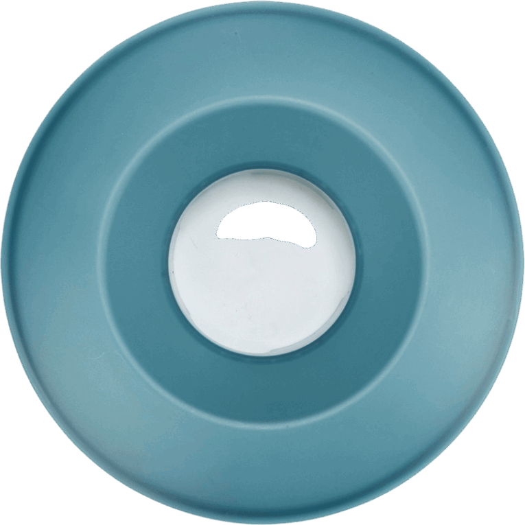 Vista cenital de la tapa superior azul del comedero Rocking Bowl de Trixie, mostrando el orificio de salida del pienso y su diseño cóncavo.